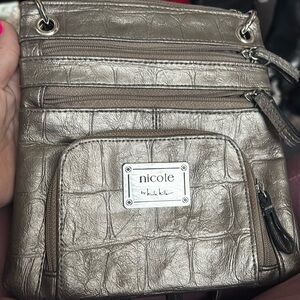 A gray purse by Nicole miller